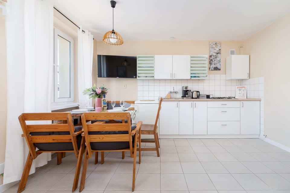 The dining area shown from another angle, with chairs and a table near the open kitchen space.
