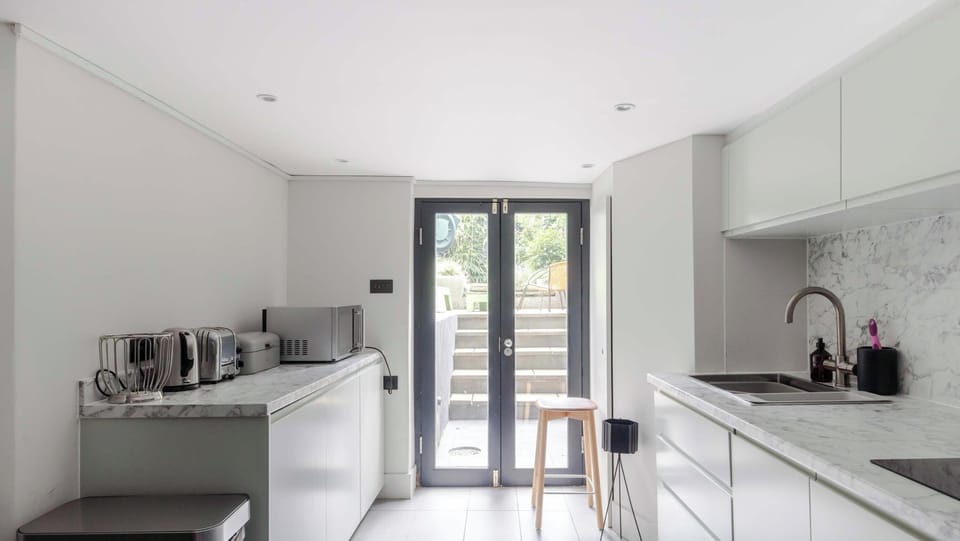 Islington Townhouse contemporary kitchen featuring a marble countertop