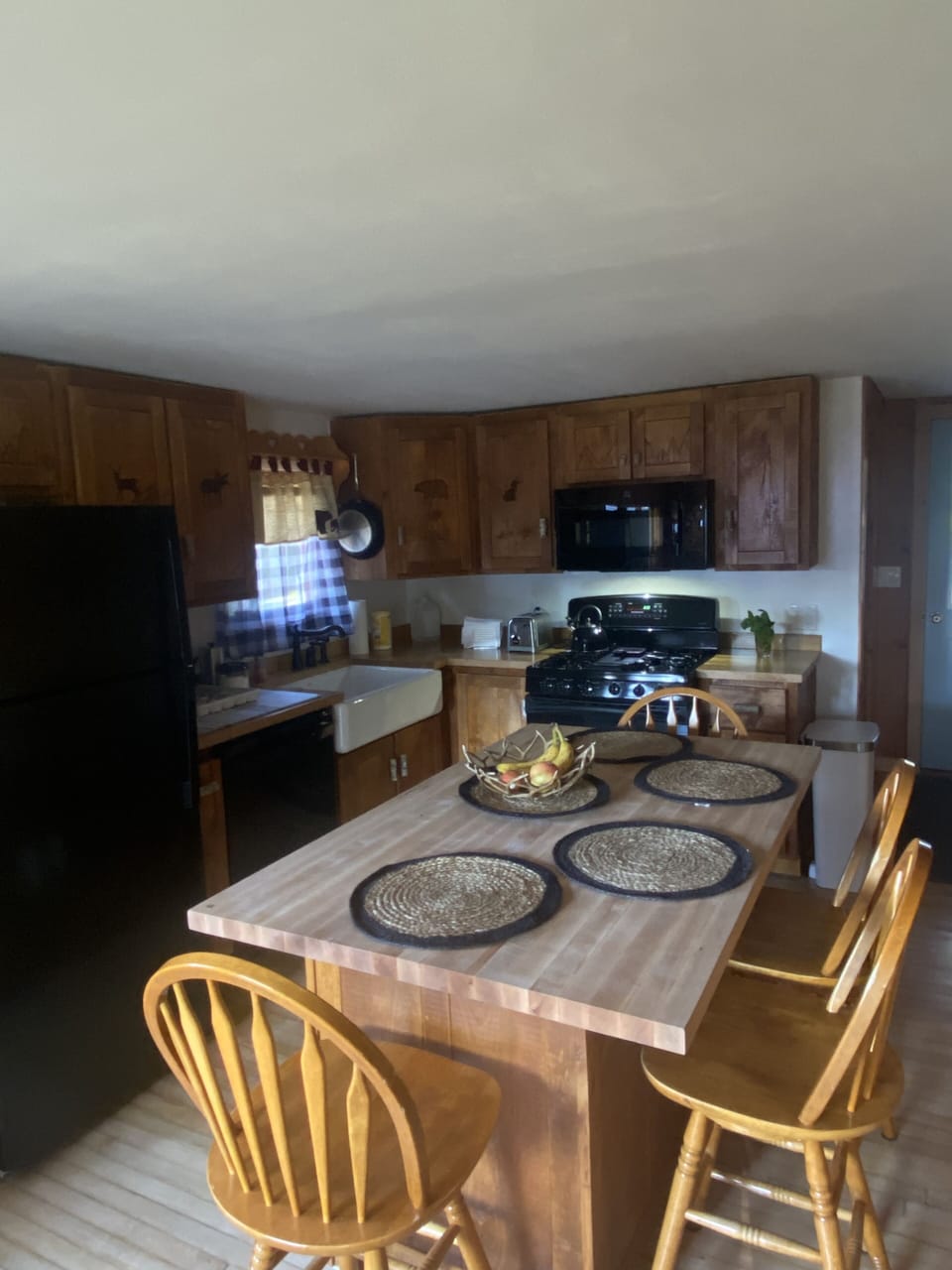 Unique, beautiful cabinets with wood handles and carvings of animals. 
