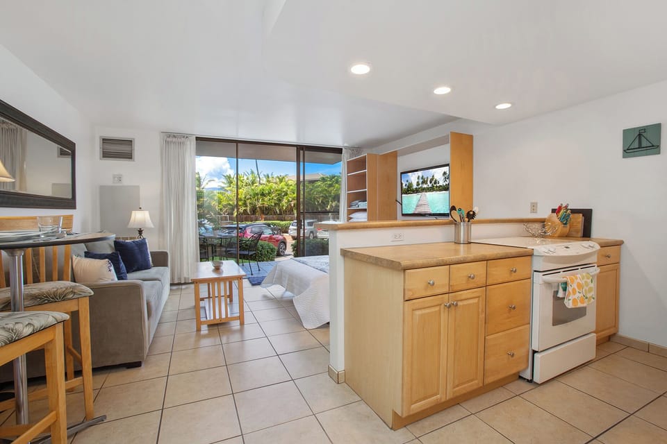 Relax in your bright, open living space where the kitchen flows effortlessly into the cozy sitting area and your private lanai opens to lush tropical views and poolside relaxation.