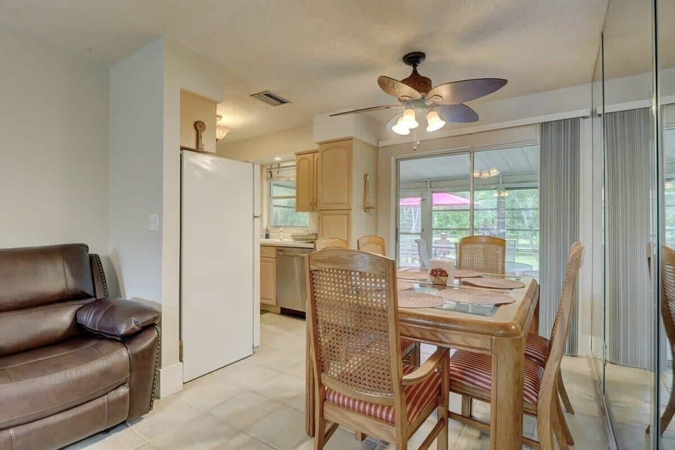 The Dining Room Connects To the Kitchen to the Left and To the Sunroom Right Behind the Sliding Doors