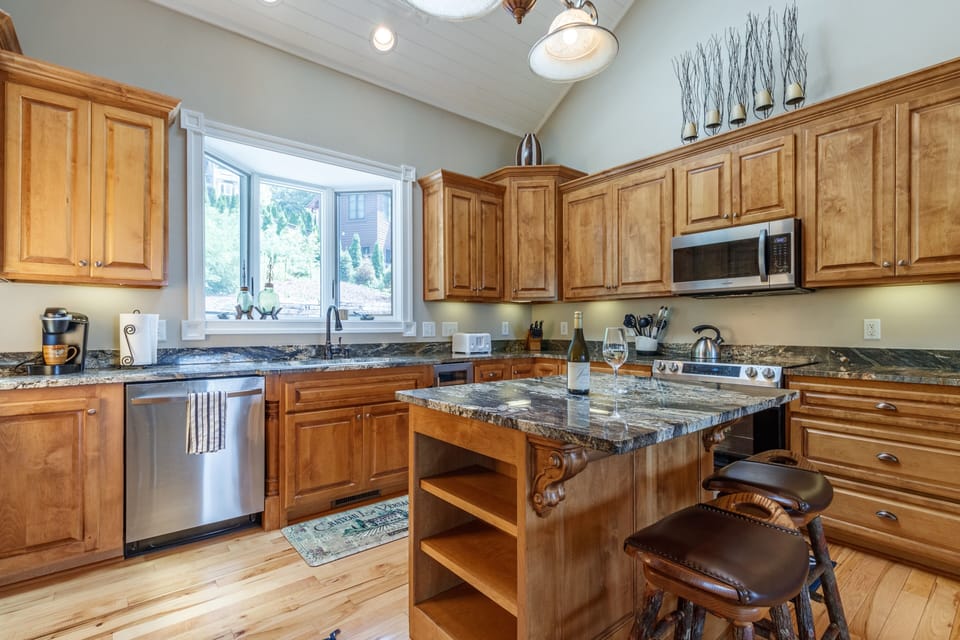 Full kitchen equipped with toaster, coffee maker, and wine cooler
