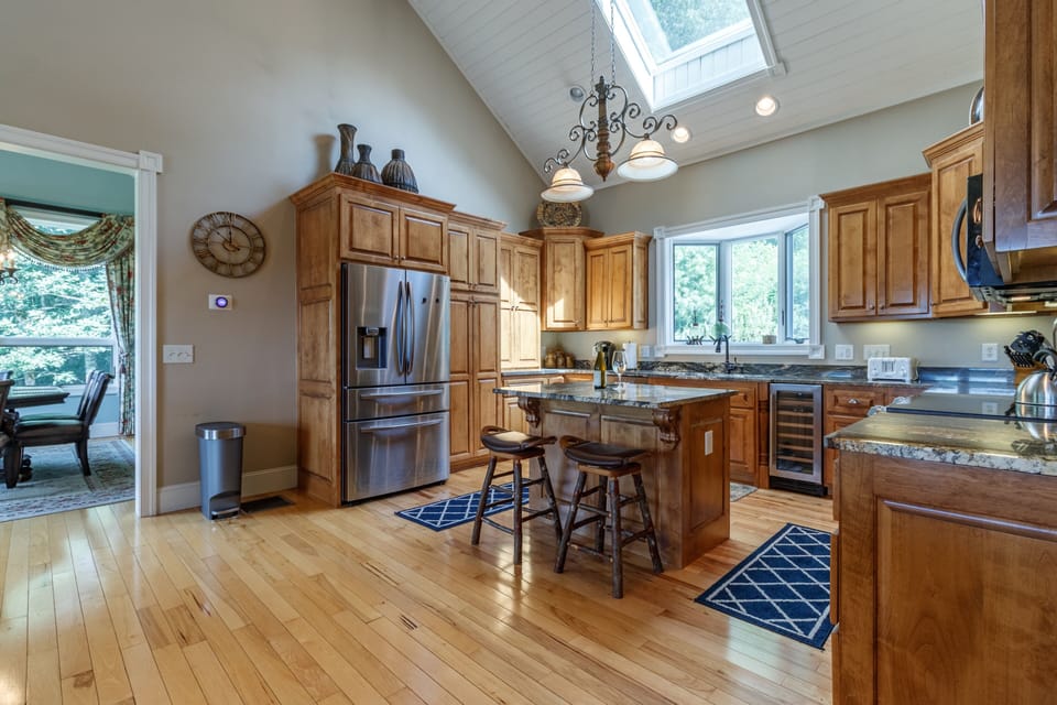 Spacious kitchen with beautiful granite countertops, and an island for prep