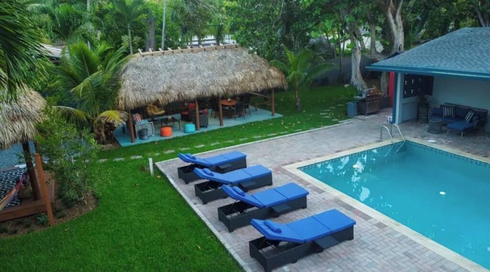 The pool, lounge chair and cabana with outdoor seating and more