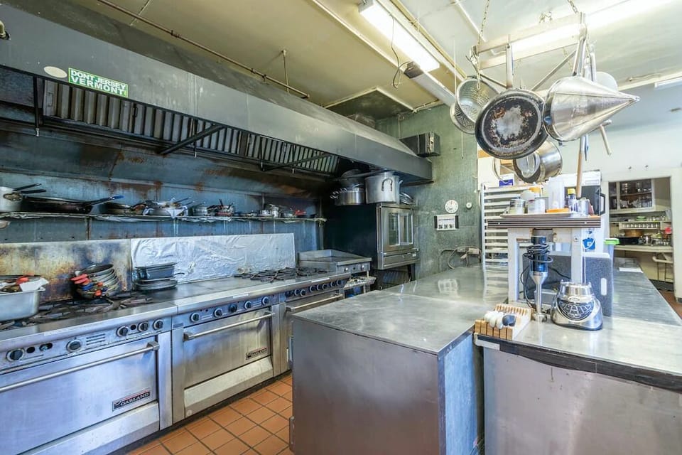 Commercial kitchen with 12 burners, convection oven, commercial dishwasher