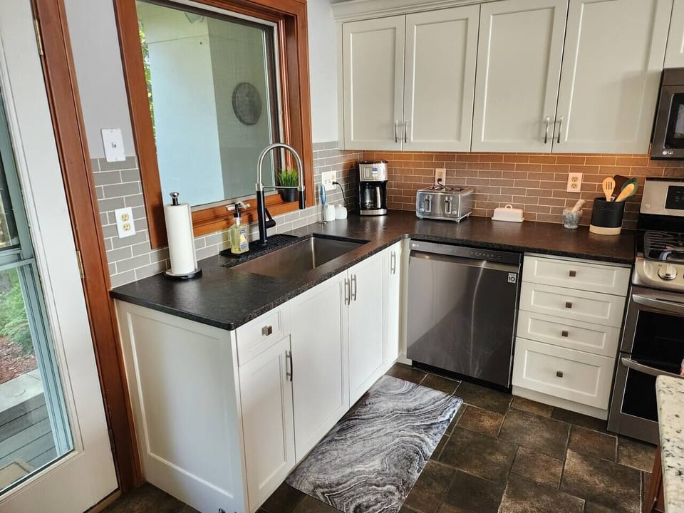 Kitchen is well stocked with a cofee maker, toaster, spices, plates, cups, silverware, etc!