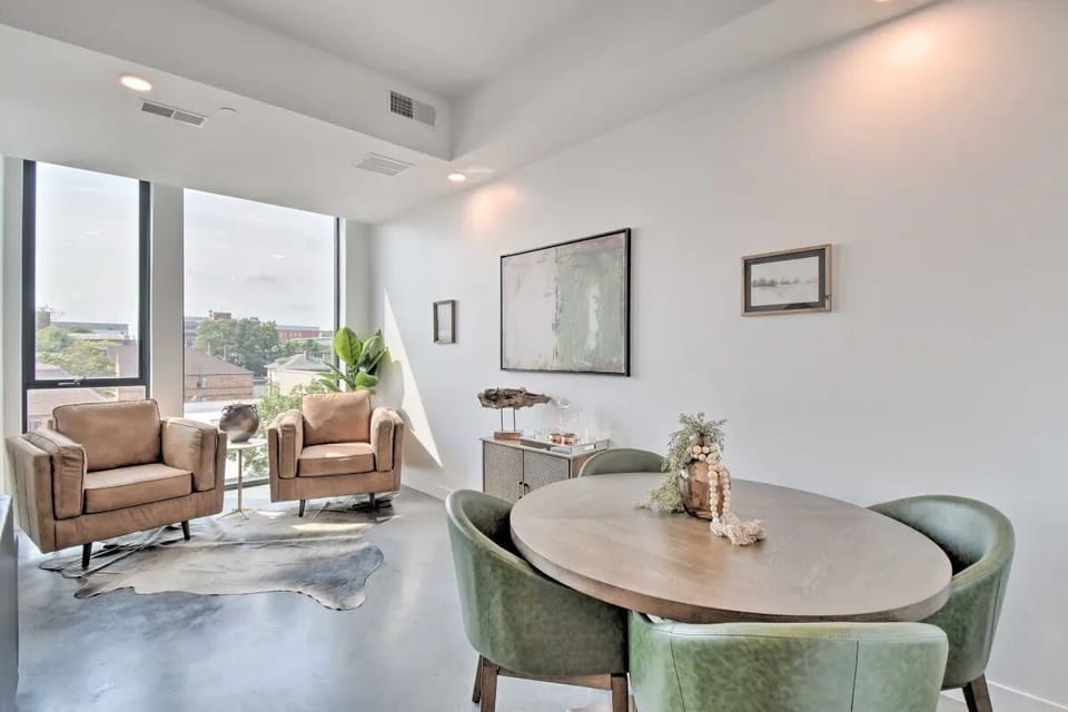 Dining table and lounge chairs to enjoy street view.  