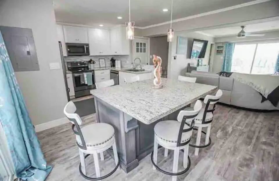 Spacious open concept kitchen with seating around island. Neutral modern tones
