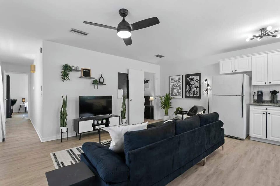 Kick back in style – our spacious black-and-white living room features a 65-inch smart TV for epic movie nights