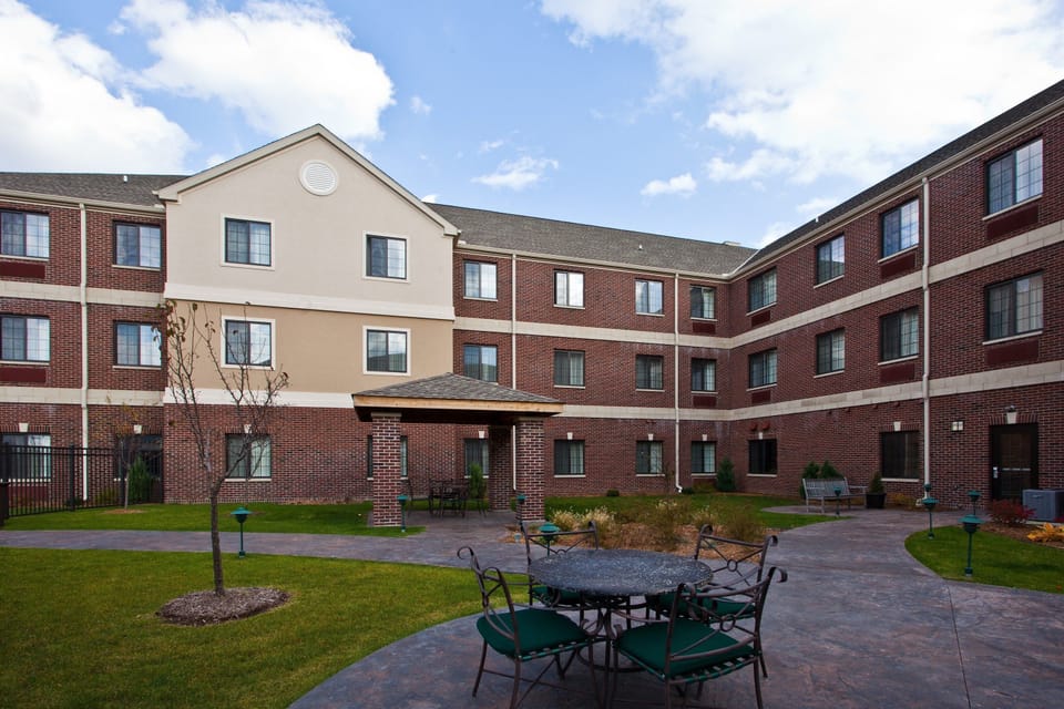 Relax in the courtyard with inviting seating beneath a quaint gazebo, perfect for unwinding.
