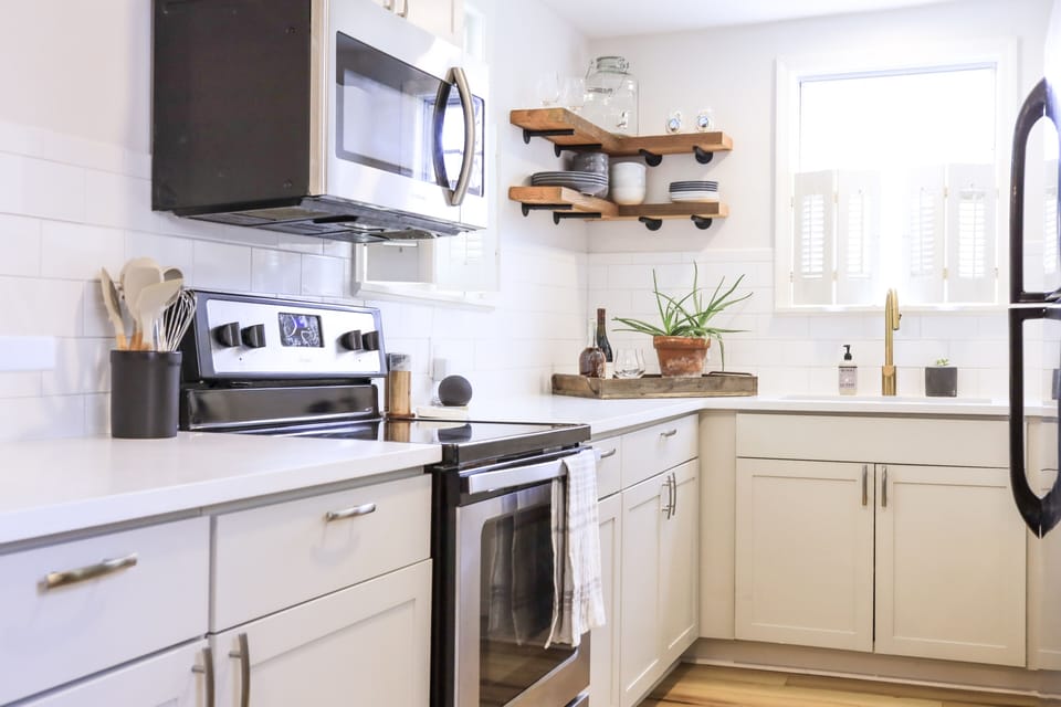 Fresh and clean kitchen with quartz countertops and tile backsplash 