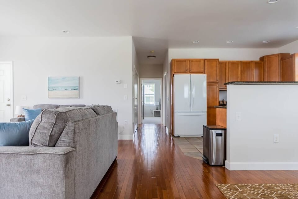 Hallway from the main living space leads to both bedrooms, bathrooms, and laundry area