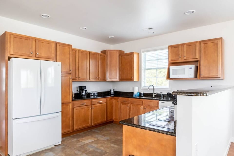 Large well stocked kitchen with granite countertops