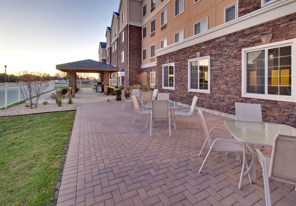 Outdoor patio with tables and shaded seating area.
