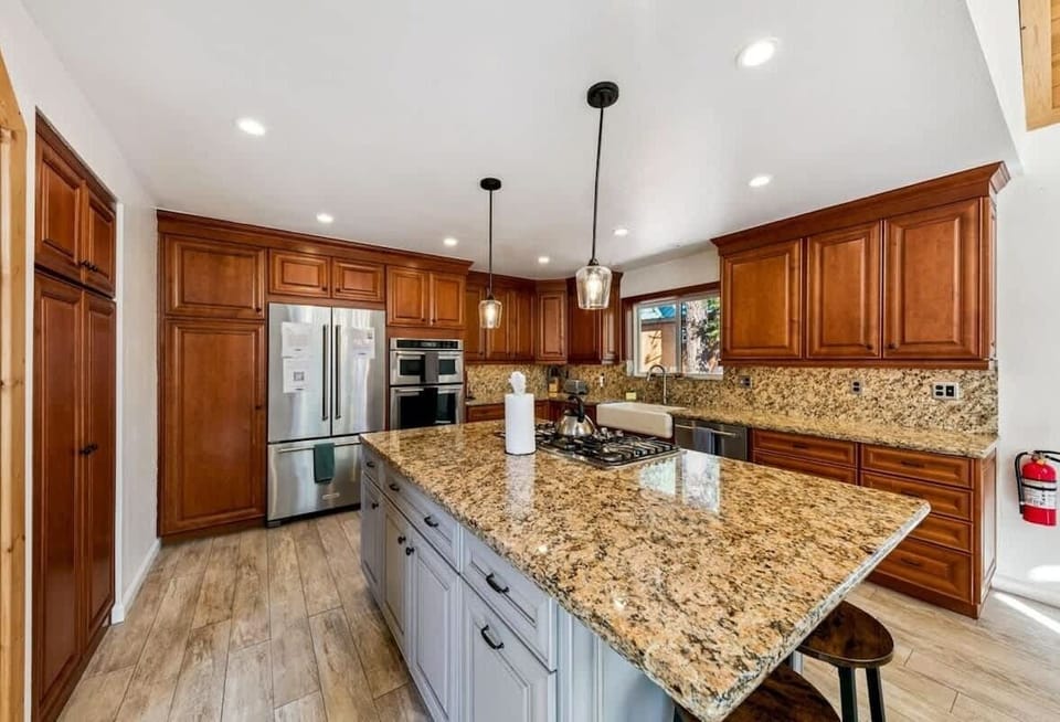 Large Tahoe Donner kitchen with granite island, gas range and ample counter space for cooking and gathering during your Truckee mountain getaway.

Fully equipped with cookware, bakeware, dinnerware and utensils.
