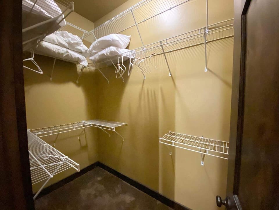 The walk-in closet offers ample space for unpacking and storing all your luggage.
