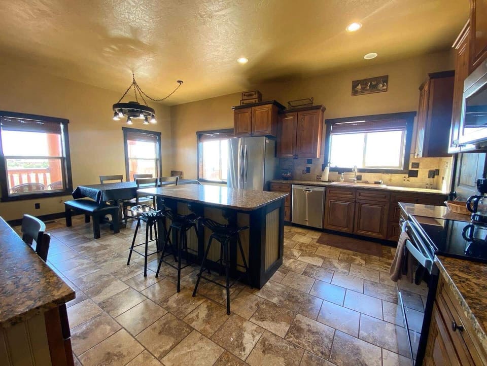 The kitchen boasts generous counter space, along with a three-seat island for casual dining and conversation.