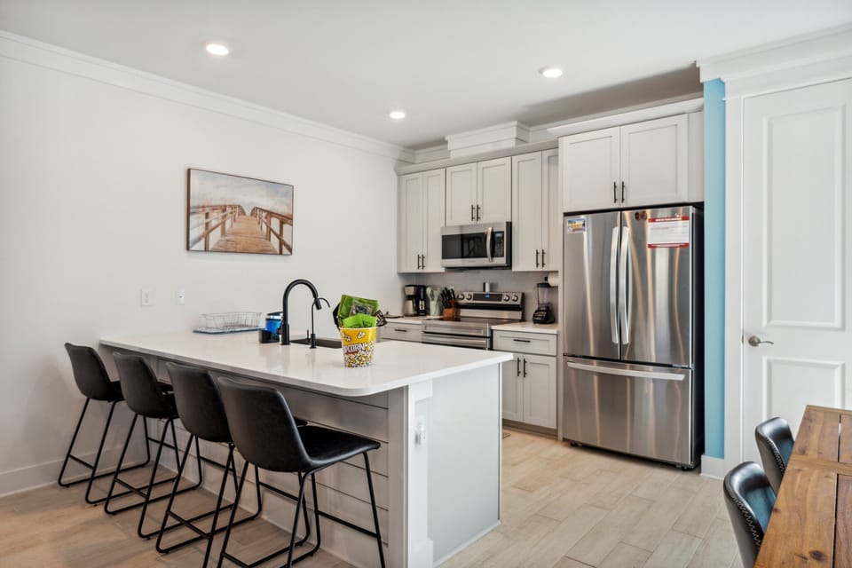 Comfortable eat in Kitchen Peninsula with stainless steel appliances. 