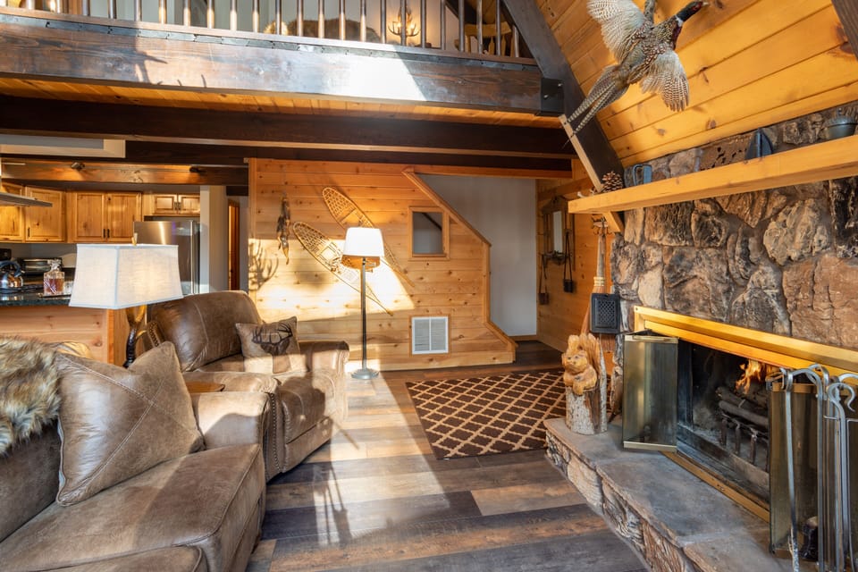Cozy living room features a fireplace and a sofa.