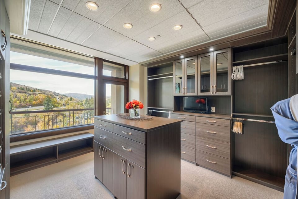 The primary walk-in closet includes built-in storage and a central island.
