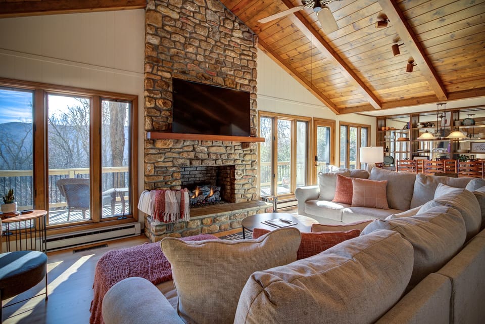 Living room with a gas fireplace, large couch and a smart TV!