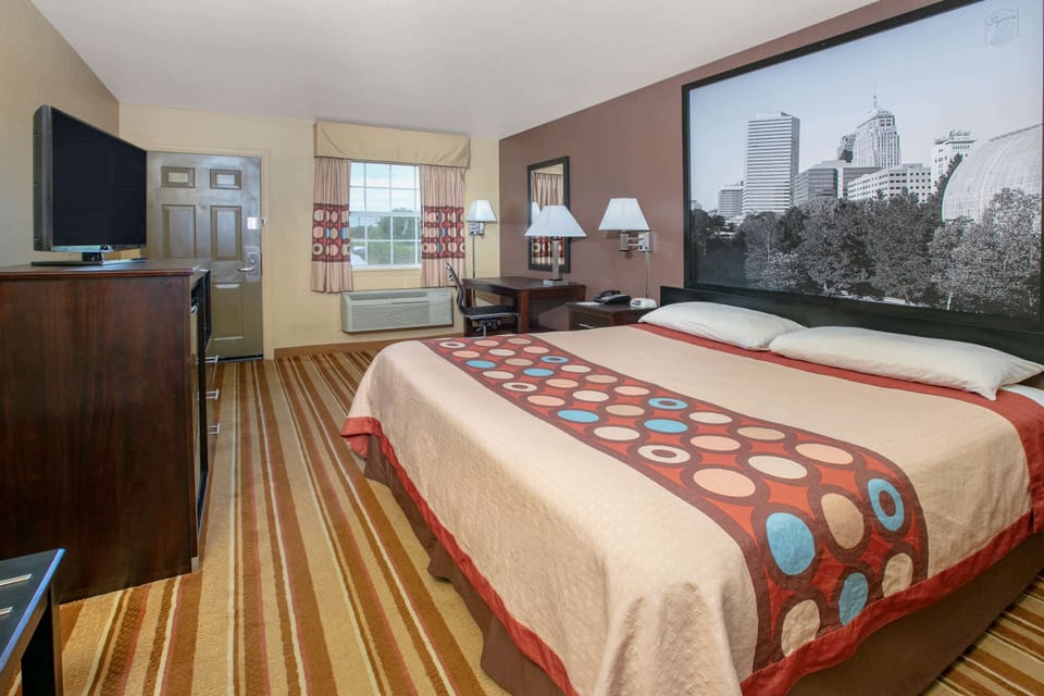 Desk, laptop workspace, blackout drapes, iron/ironing board