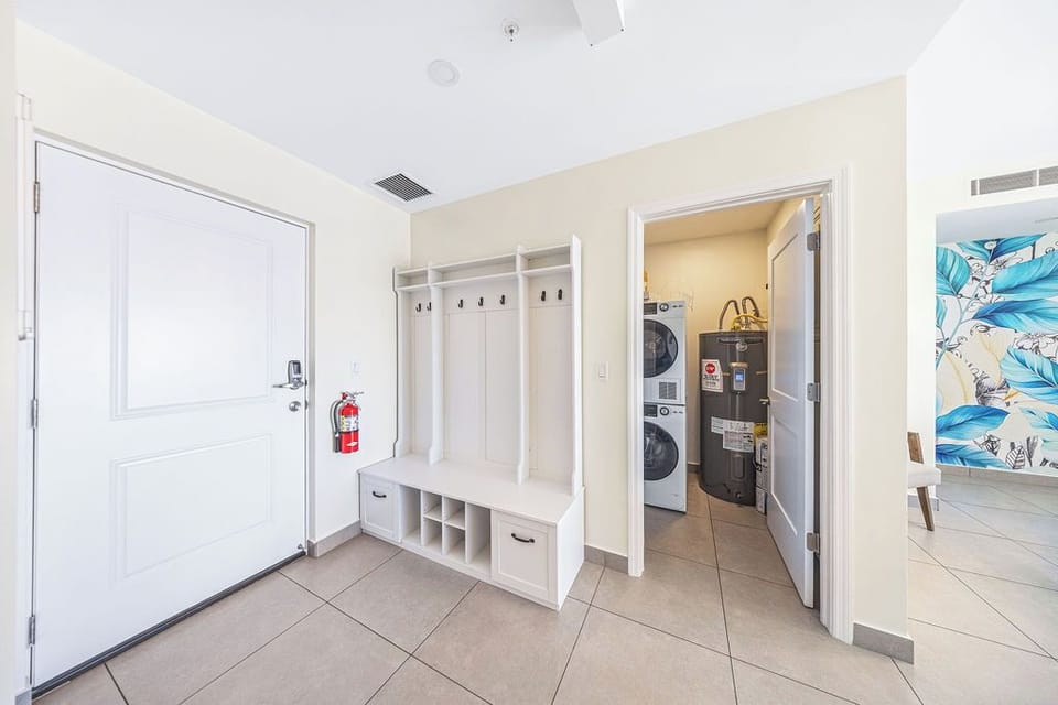 A welcoming entryway greets you with smart storage cubbies and hooks for beach gear, plus convenient laundry right next door—keeping your vacation clutter-free and comfortable.