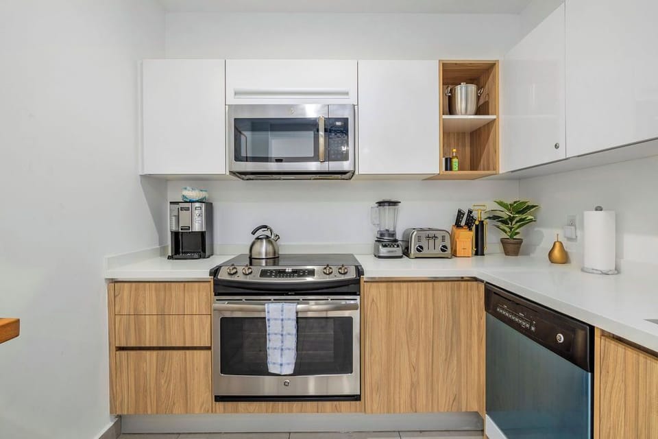 Step into your modern bathroom with a sleek glass-enclosed shower, plush towels, and a vanity stocked with premium amenities—your private retreat awaits.