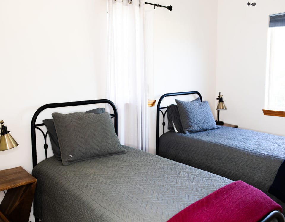Two twin beds located in third bedroom of the house.