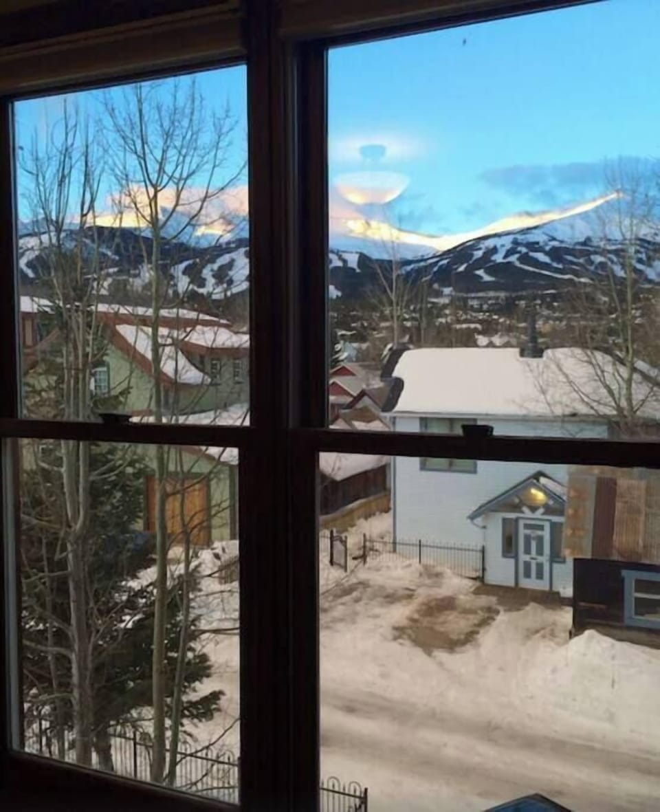 Historic Breck Panorama — Overlook the historic district as the sky glows above charming rooftops and colorful homes. 🌅🏘️