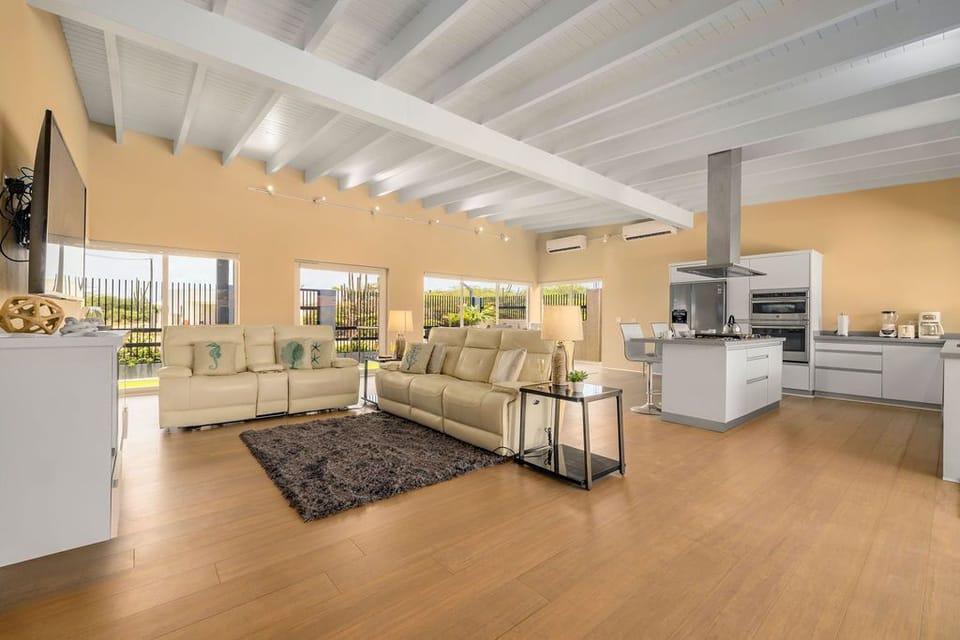 This bright and spacious open-concept living room and kitchen area invite you to spend the entire day chatting with your friends and preparing scrumptious meals.