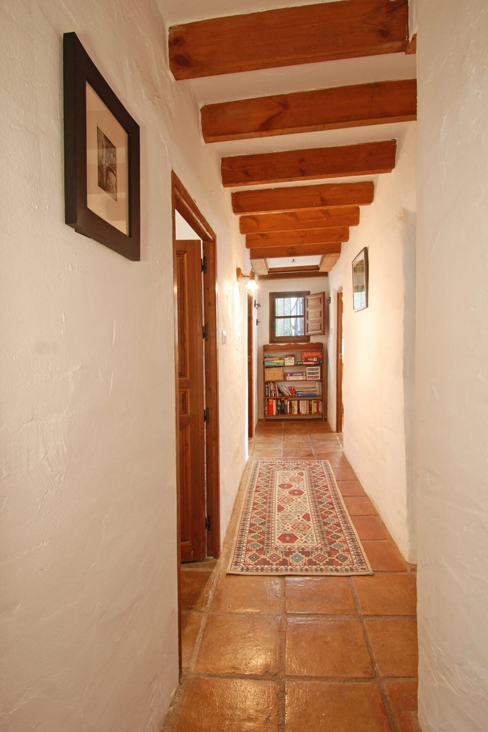The hall leads to the bedroom and bathroom area and also has a book corner.