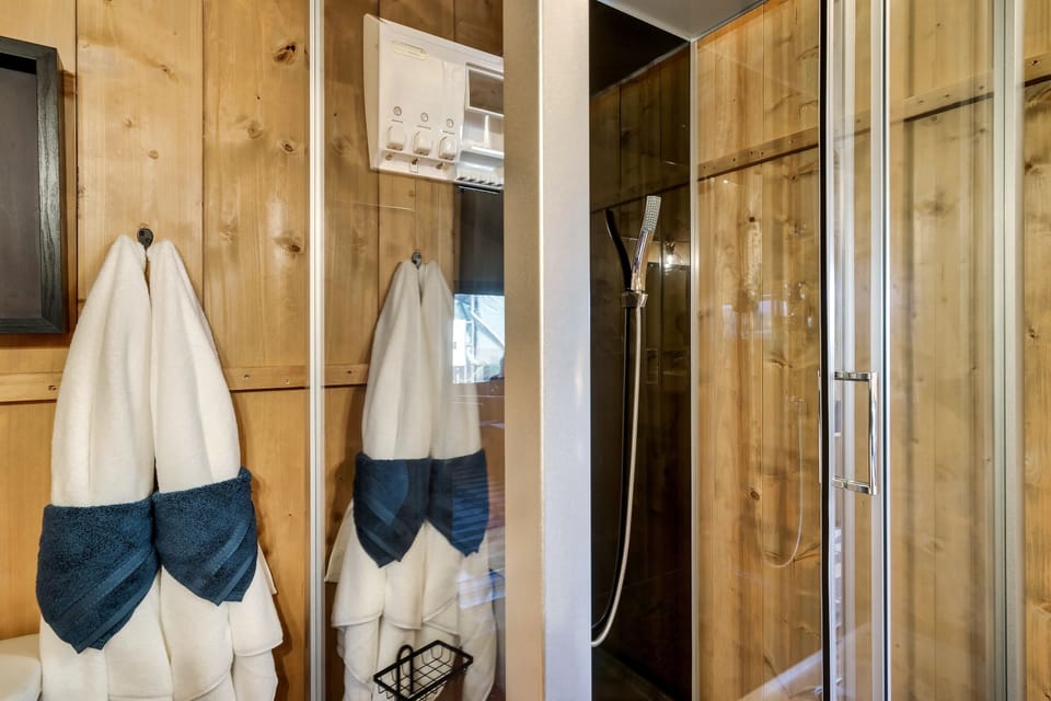 A glass shower with a rain shower head and great water pressure!