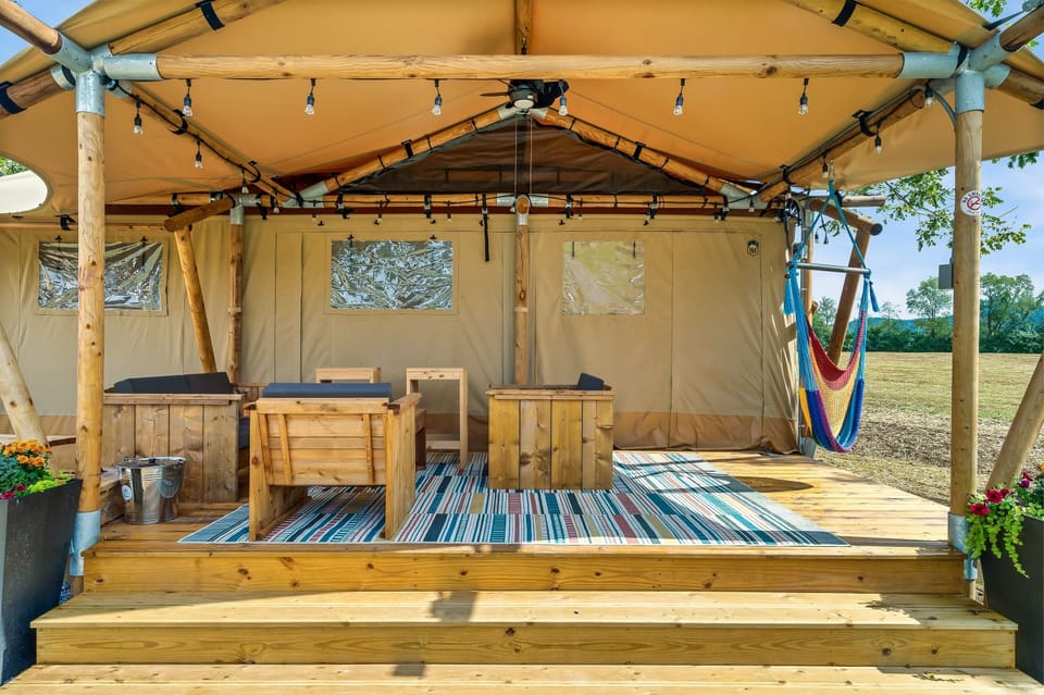 A covered porch with a fan to help keep you cool and dry.