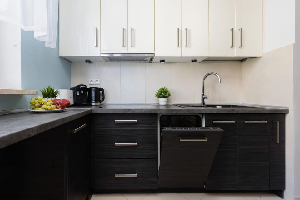 Kitchen with plenty of kitchen utensils and dishes. 