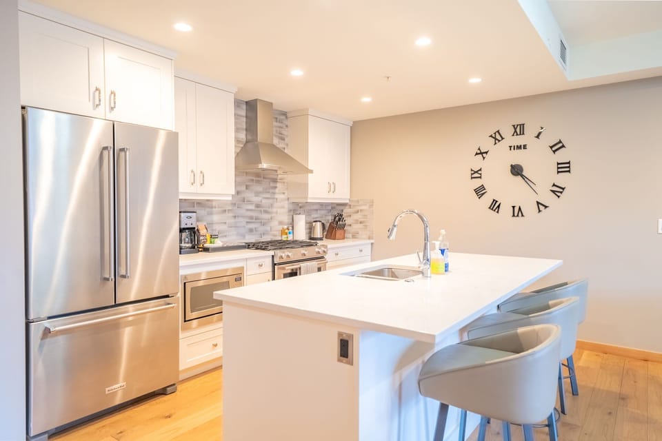 Cook up your favorite dishes in this sleek, modern kitchen equipped for any culinary adventure.