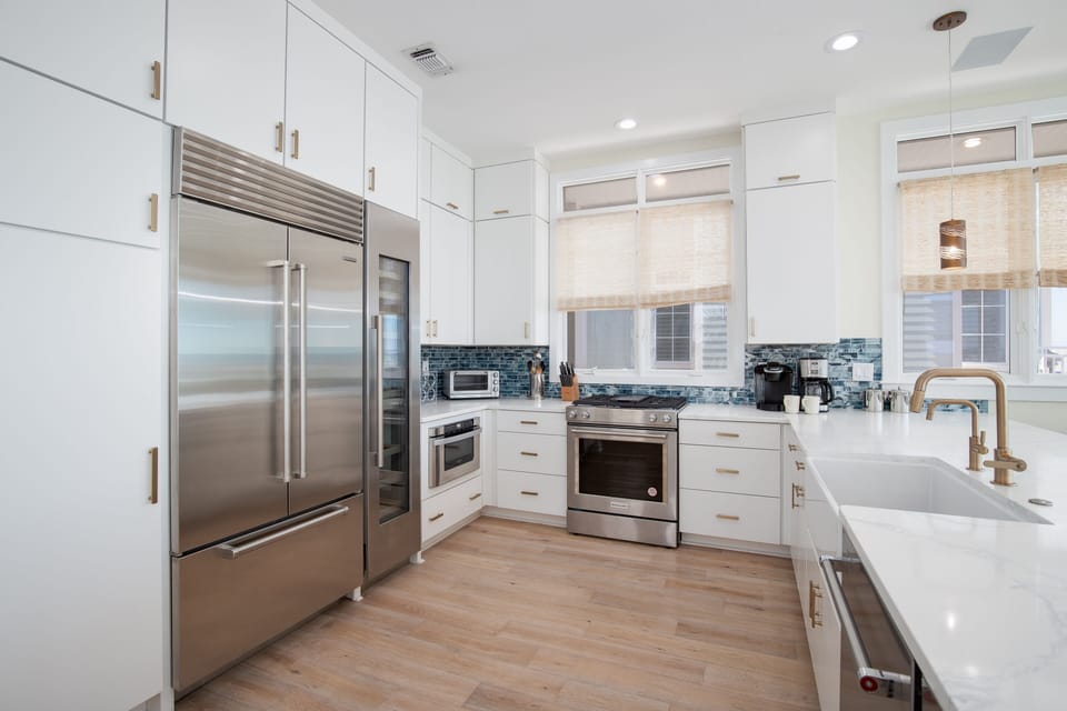 In the kitchen, there is a gas range, new stainless steel appliances, Sub-Zero refrigerator, wine cooler, and under-counter ice maker.