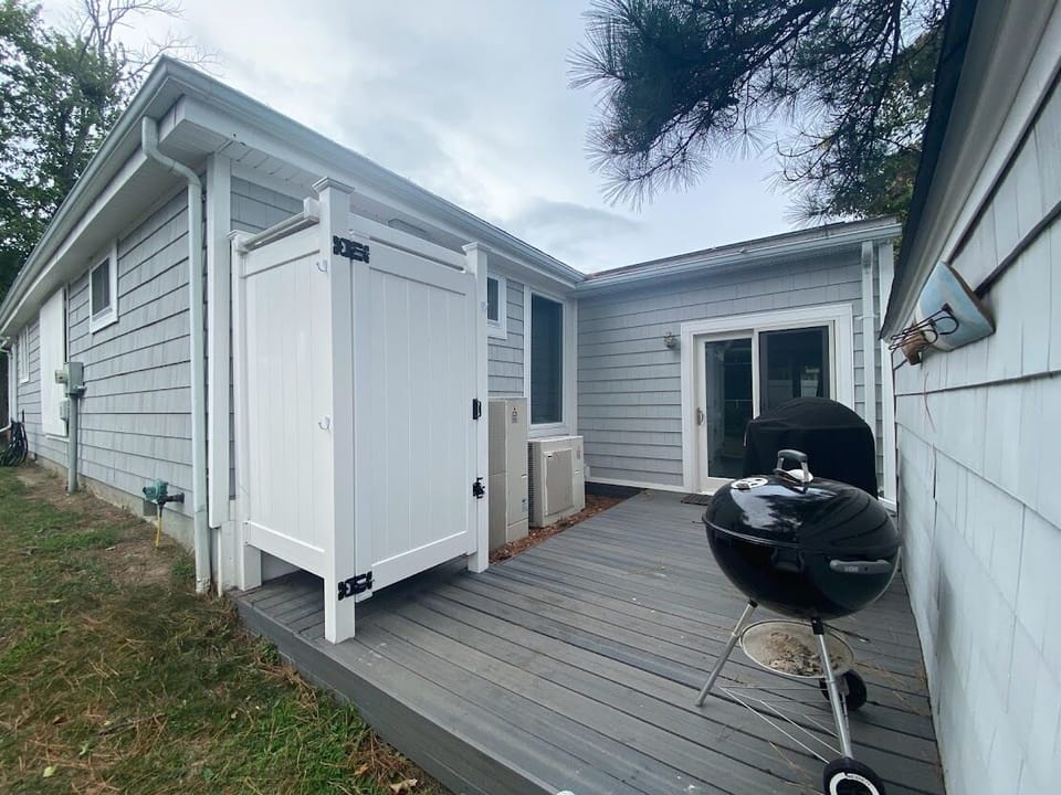 Outdoor shower and deck with both a gas (Fuego) grill and a Weber charcoal grill
