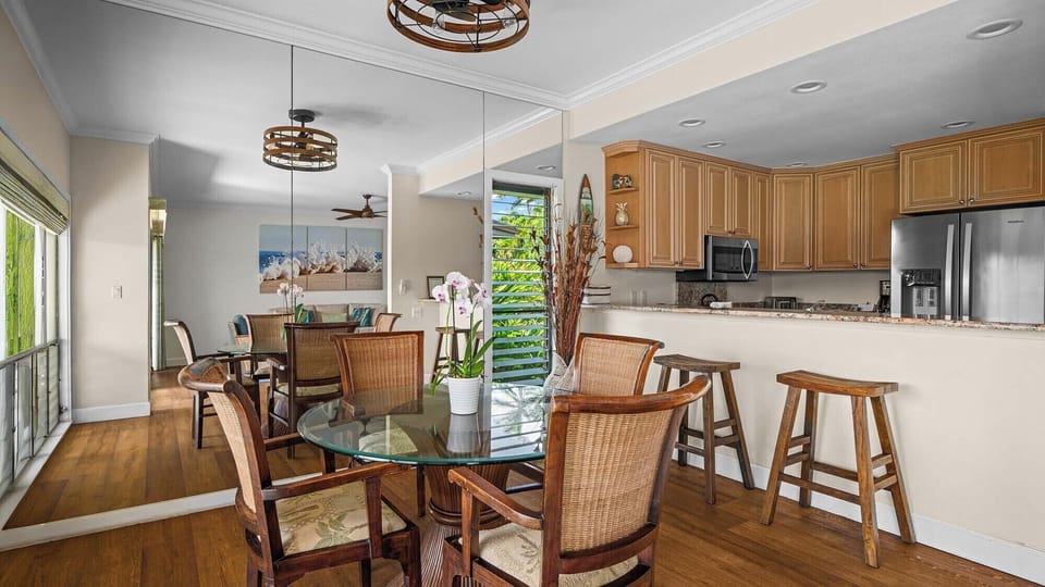 Gather around this stunning open-concept kitchen and dining space, where warm wood tones create the perfect atmosphere for memorable meals together.