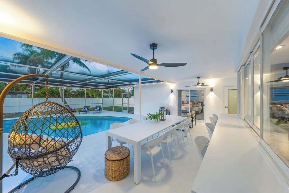My fav part of the house - 8-person outdoor dining set perfect for dinner watching sunset.  Passthrough kitchen which is super convenient for the chef / bartender of your group to serve food without having to walk out of the kitchen. + 2 ceiling fans
