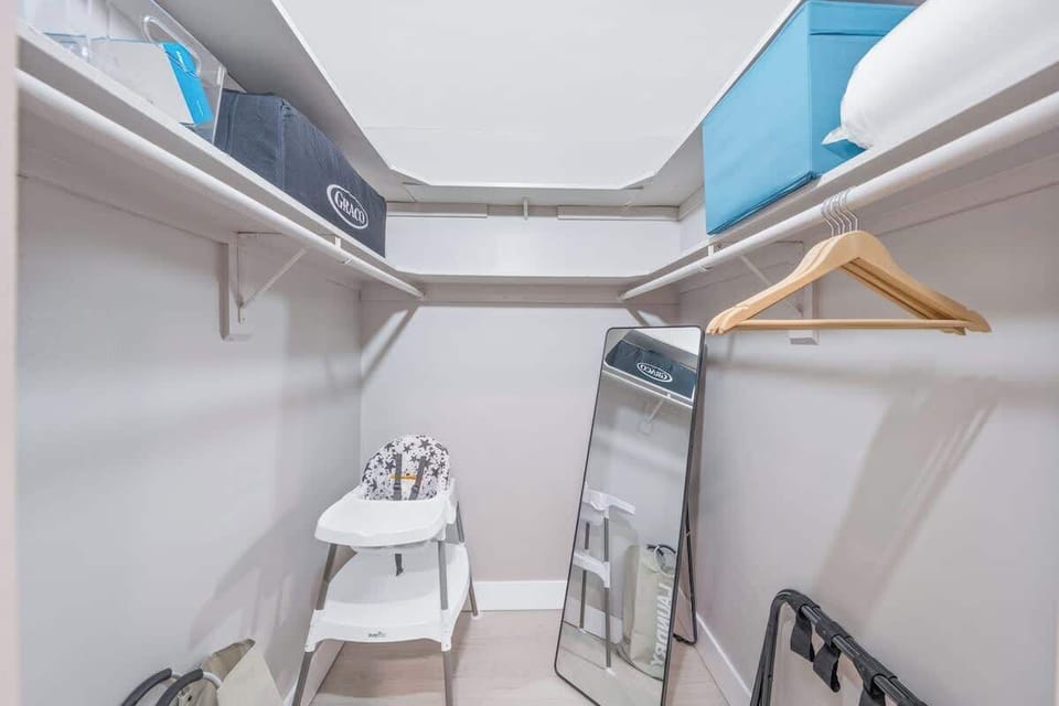 Master bedroom suite closet - 1 high chair, 1 pack and play, full length mirror, luggage rack, laundry basket, hangers, outlet extender etc, iron and iron board.