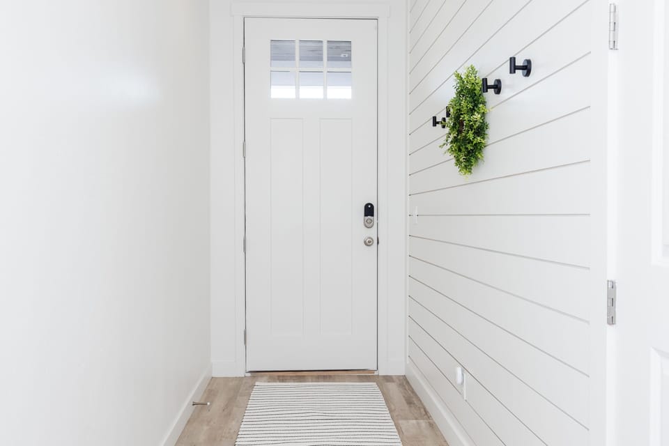 Beautiful entryway with space to hand coats, jackets, etc.