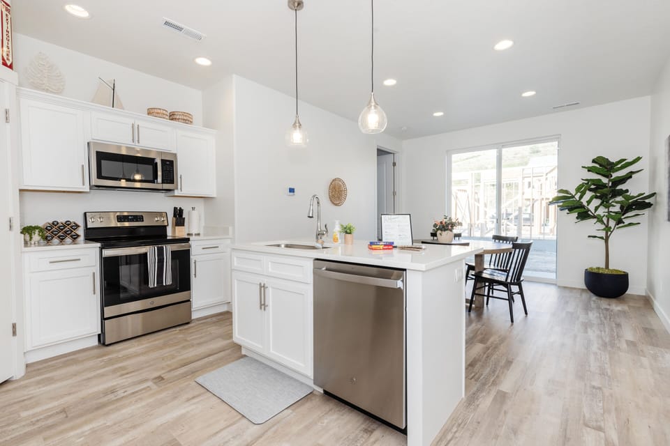 Main-level kitchen and dining room off back patio. Seats 9.