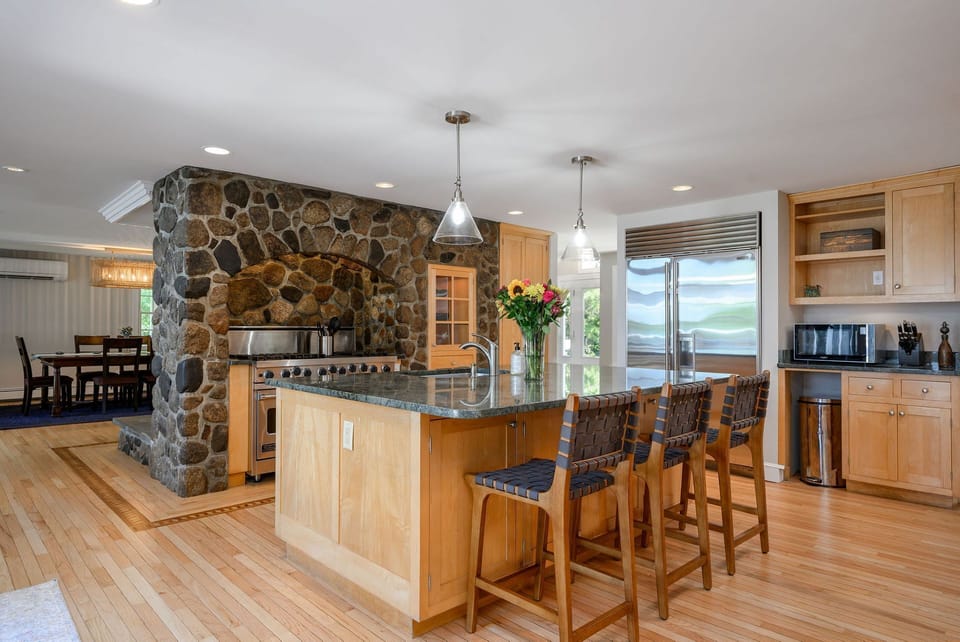 Kitchen with island and six-burner gas stove
