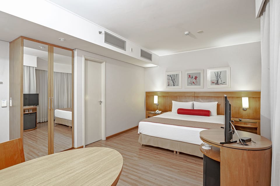 Deluxe Double Room | Minibar, in-room safe, desk, blackout drapes