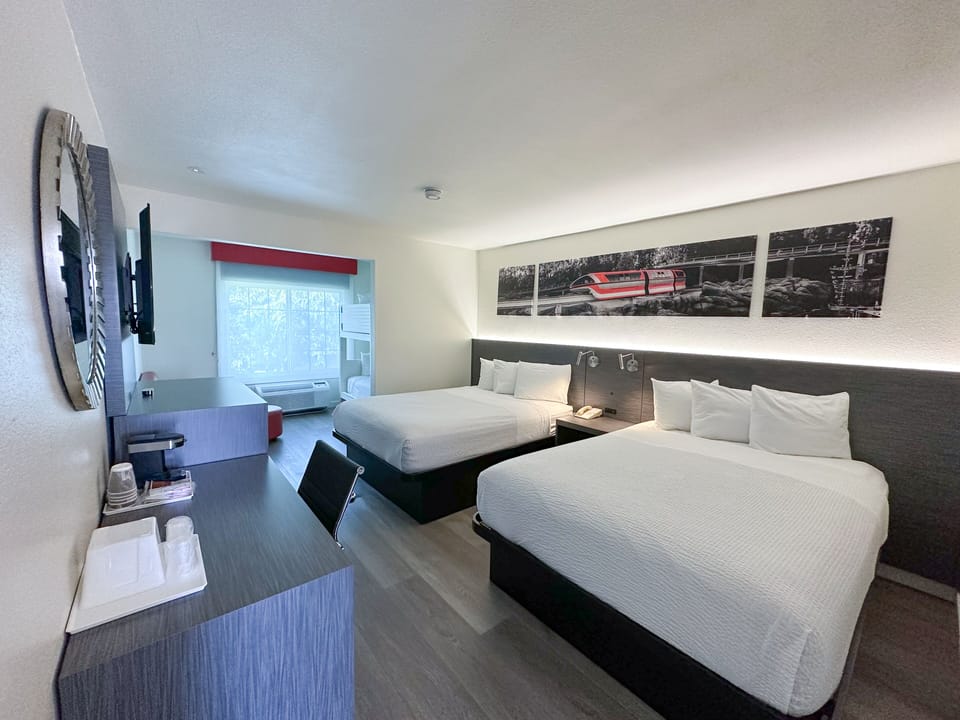 Junior Suite, Non Smoking (2 Queen Beds & 1 Bunk Bed) | Desk, laptop workspace, iron/ironing board, cribs/infant beds