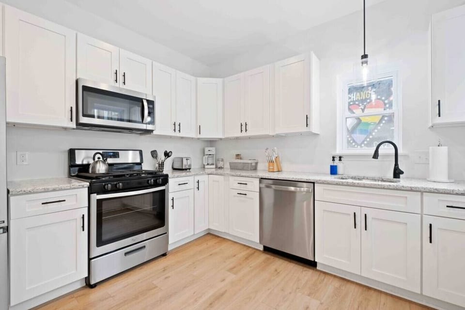 Modern kitchen featuring sleek stainless steel appliances and ample counter space.