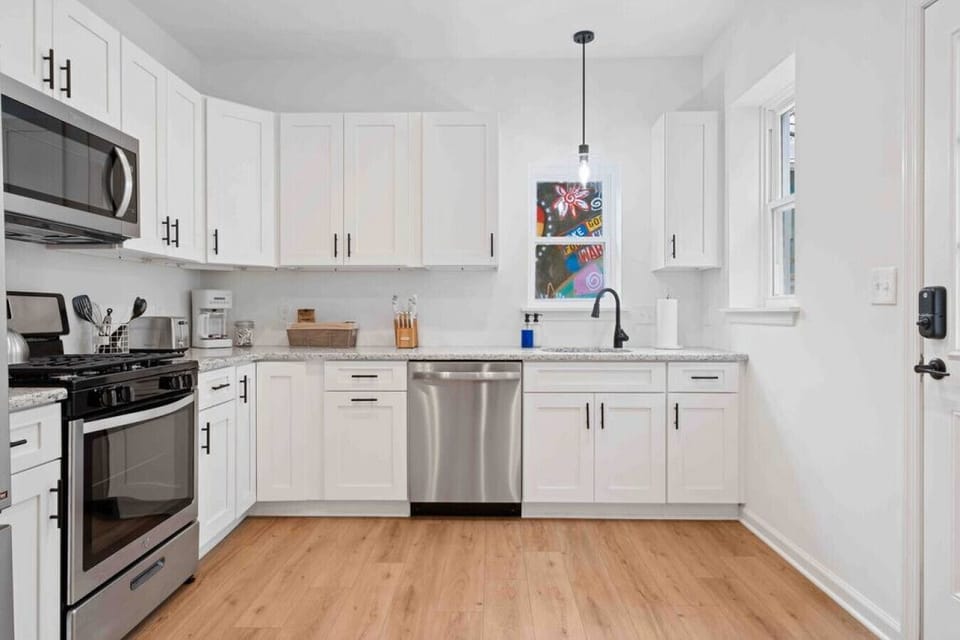 Modern kitchen with stainless steel appliances and ample counter space, perfect for cooking up a storm