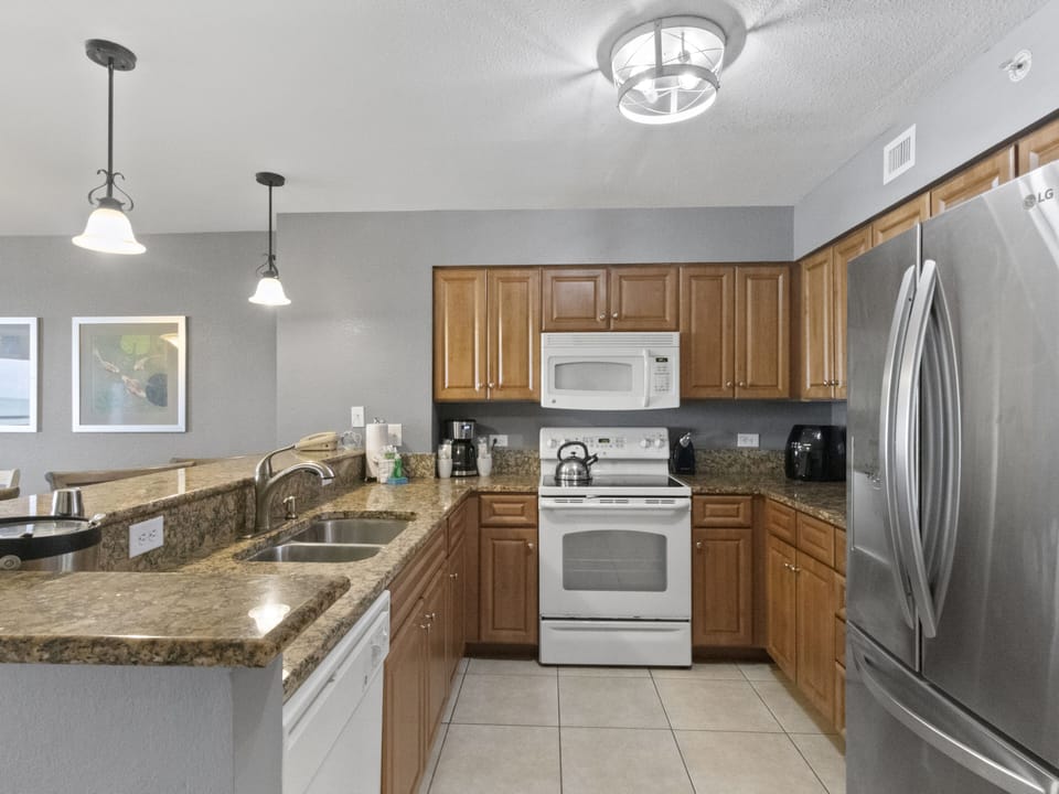 Your fully equipped kitchen features granite counters, stainless steel appliances, and warm wood cabinets - perfect for preparing your favorite meals.