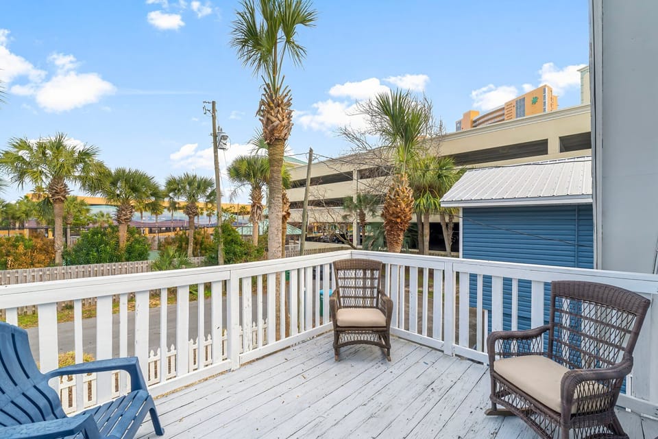 Two queen beds with Smart TV and private balcony access — perfect for couples or additional guests.